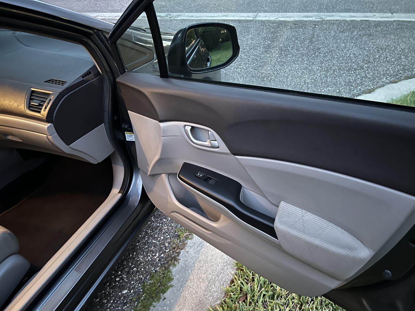 Clean door panel and dashboard inside a Honda Civic after an interior detail