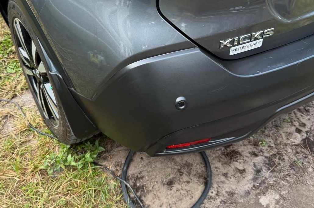 After: restored, darker rear bumper trim on the same Nissan Kicks