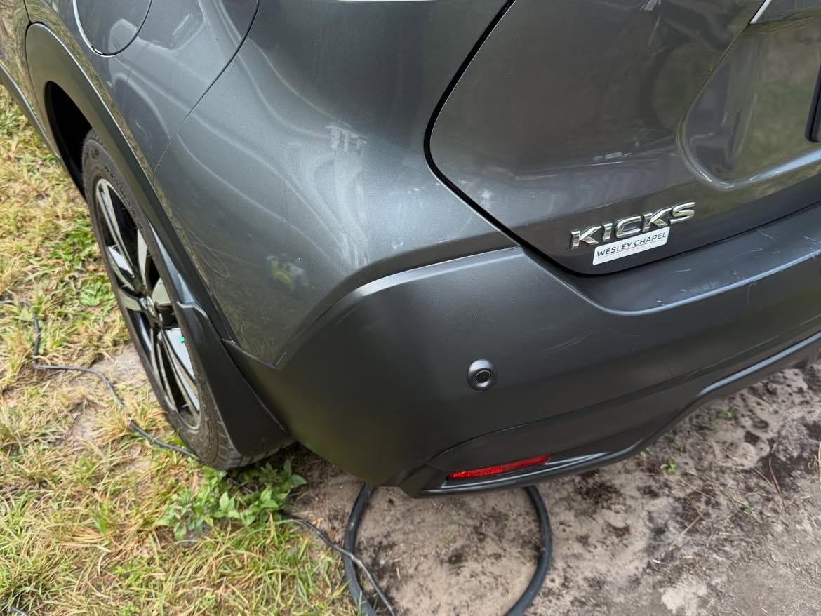 Restored black plastic trim and bumper on a gray Nissan Kicks