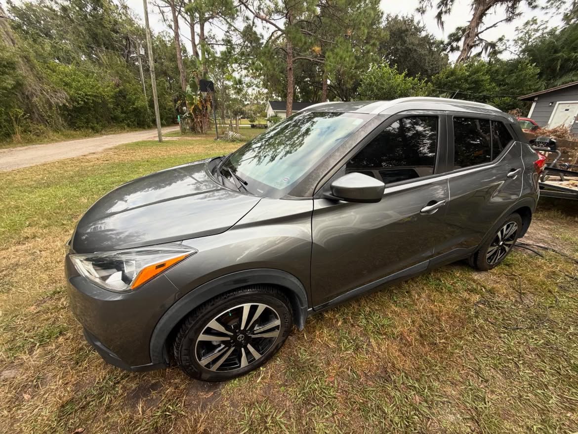 Gray Nissan Kicks detailed by Acton Detailing on a Lutz-area lawn