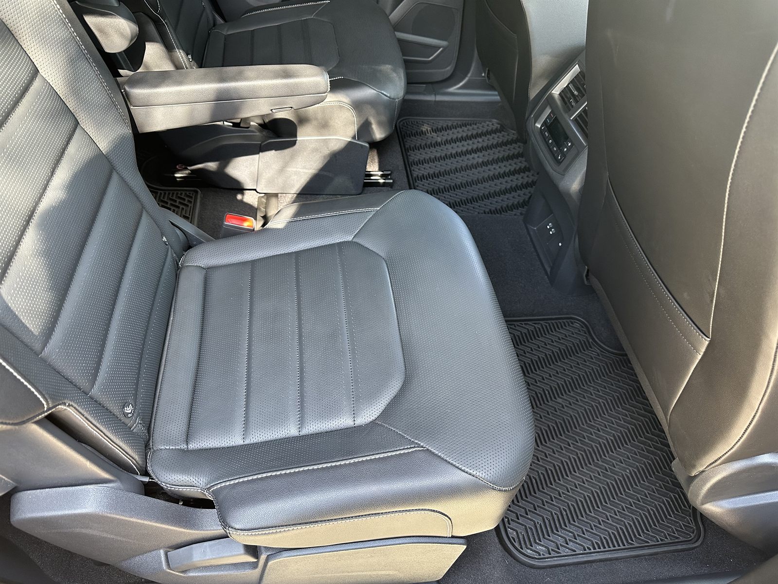 Clean leather seats and rubber floor mats inside an SUV after an interior detail in Lutz, Florida